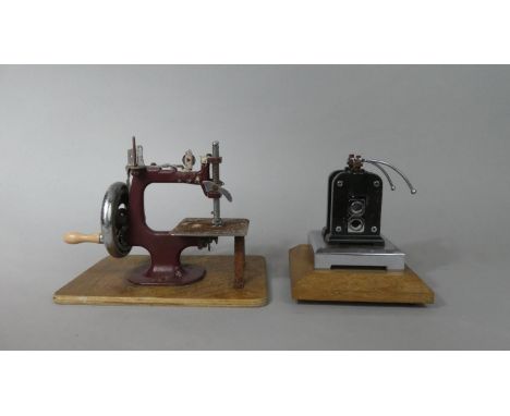 A Vintage Rolling Press Mounted on Wooden Plinth Together with a Small Childs Sewing Machine 