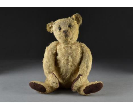 An early Steiff teddy bear circa 1909, with golden mohair, black boot button eyes, pronounced clipped muzzle, black stitched 