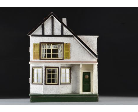 A Tri-ang A-symmetric dolls’ house DH/D 1924, with pebble-dashed exterior, ground floor bay window, green front door with lio