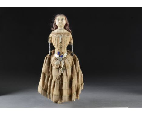 An interesting English dipped wax doll, with pupiless glass eyes, heavy dark grey brows, unusual ringletted dyed purple wig s