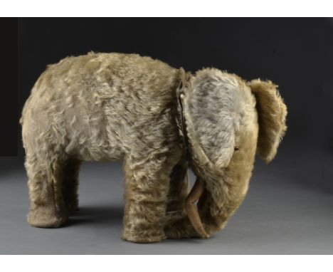 A ISA Chad Valley elephant 1930s, with grey mohair, replaced small orange and black glass eyes, cloth tusks and soles of feet
