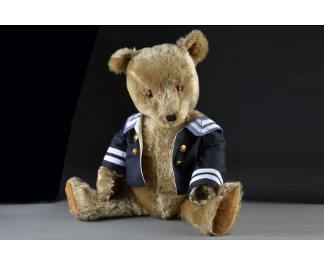 A large Chiltern Hugmee Teddy Bear, 1950s, with blonde mohair, orange and black glass eyes, black stitched nose, mouth and cl