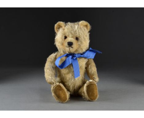 A Chiltern Ting-a-Ling teddy bear 1950s, with blonde mohair, orange and black glass eyes, pronounced inset short mohair muzzl