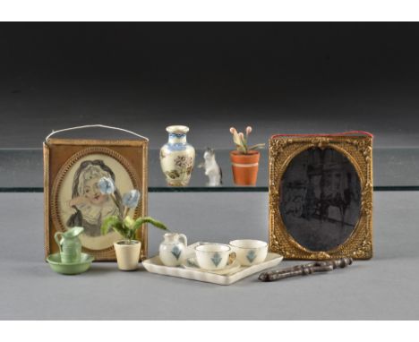 Dolls’ house chattels: including a Goss forget-me-not tea for one; a bisque kitten; two plant pots; a jug and basin; and two 