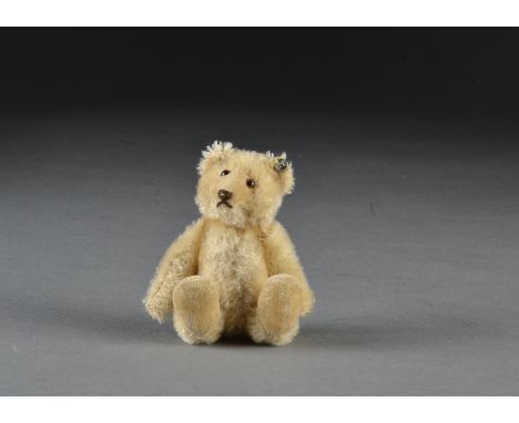 A Steiff post-war miniature Teddy Baby, with light golden mohair, brown and black glass eyes, inset velvet muzzle, brown stit