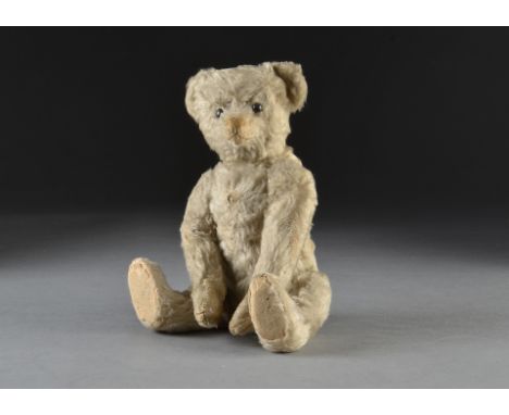 A rare Bing white mohair teddy bear with button circa 1910, with black boot button eyes, brown stitched nose, mouth and claws