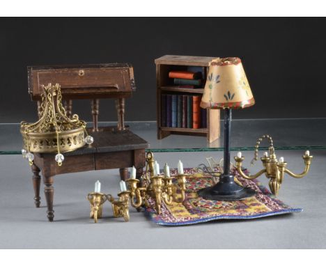 Dolls’ house furniture: a dark wood extending dining table - 41?4n. (11cm.) long; a five branch cast-metal chandelier and two