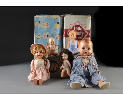 Vinyl and hard plastic dolls: a Little Beauty vinyl doll - 14in. (351?2cm.) high; a Pedigree hard plastic baby doll; and a vi