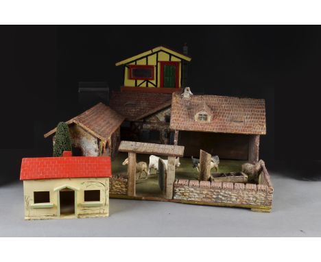 An Elastolin farm yard No15124 1/2, with house, barn, gate and wall surrounding yard - 221?2in. (57cm.) wide (wood worm); two