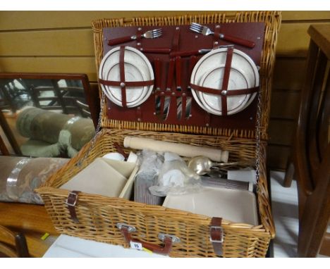 A wicker picnic hamper and contents