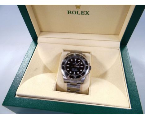 A ROLEX OYSTER PERPETUAL SUBMARINER SUPERLATIVE CHRONOMETER with stainless steel bracelet, graphite dial and bezel, complete 