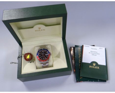 A ROLEX OYSTER PERPETUAL DATE GMT-MASTER II SUPERLATIVE CHRONOMETER with stainless steel bracelet, graphite dial, red and blu
