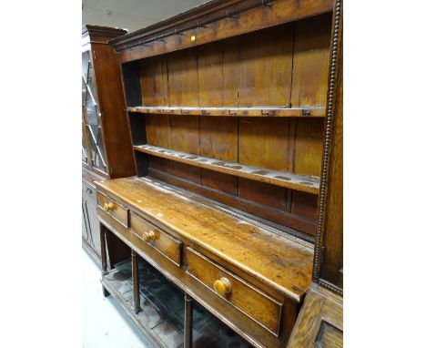 A nineteenth century Welsh dresser having a platform base, three drawers and two-shelf rack (some condition issues)