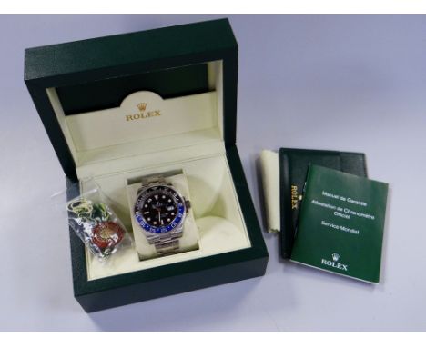 A ROLEX OYSTER PERPETUAL DATE GMT-MASTER II SUPERLATIVE CHRONOMETER with stainless steel bracelet, black dial and two-tone bl