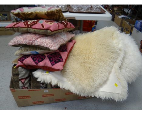 Three sheepskin rugs and sundry tapestry cushions etc
