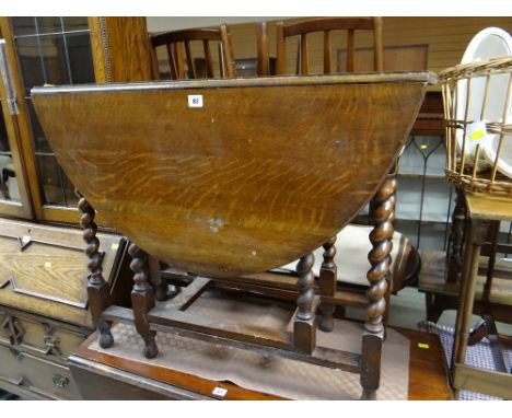 A vintage drop leaf barley-twist gate legged table