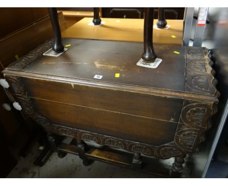 A vintage carved and shaped-top barley-twist gate legged table
