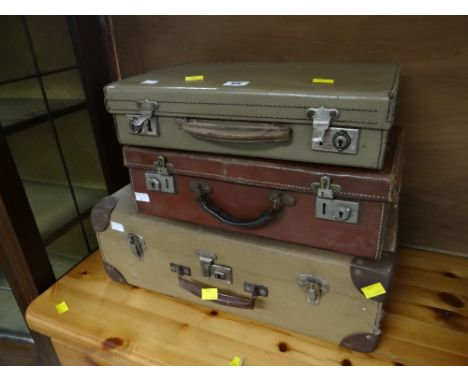 Three small vintage suitcases and a larger trunk