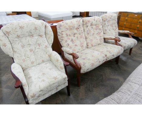 A two seater wood framed settee in cream floral patterned covering with one matching chair and an odd wood framed fireside ch