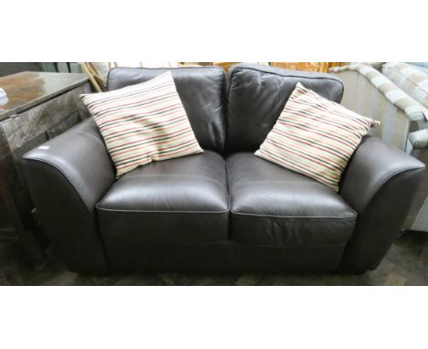 A small chocolate brown leather two seater sofa with scatter cushions 