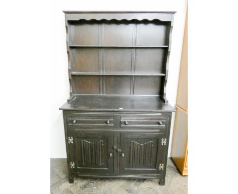 A reproduction oak Welsh style dresser with shelf back and linen fold panel cupboards under 3'6 wide  