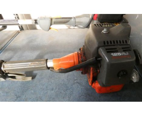 A Husqvarna petrol engine strimmer in full working order 