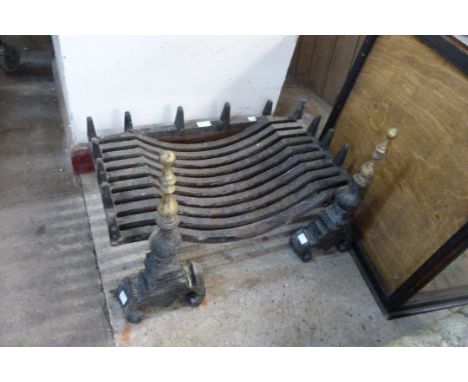 A cast iron fire grate with andirons 