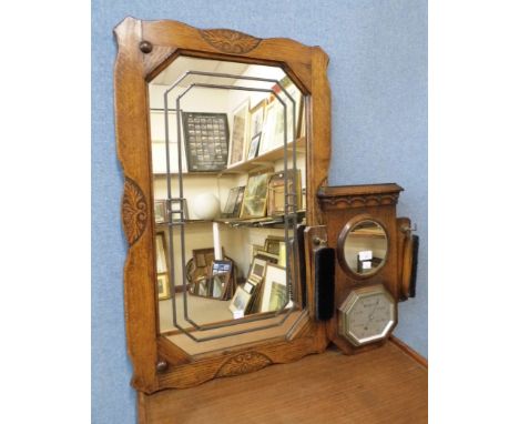 An Art Deco oak aneroid barometer, mirror and brush set and an oak mirror 