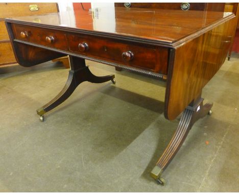 A George IV mahogany double sided four drawer drop-leaf sofa table 