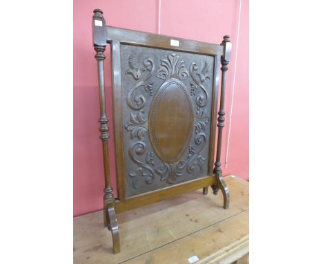 An Edward VII carved mahogany firescreen 