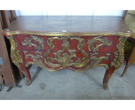 A French Louis XIV style scarlet and gilt serpentine commode 