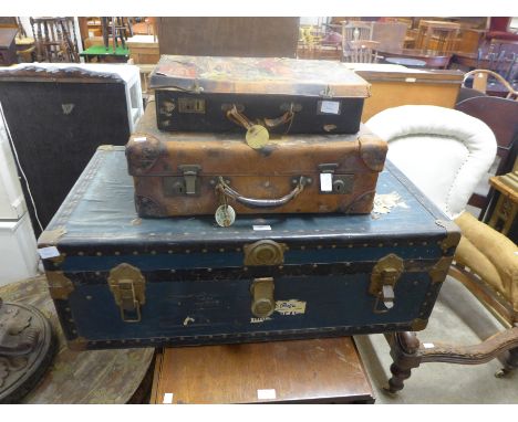 A vintage steamer trunk and two briefcases 