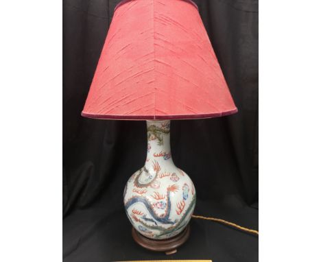 Early Chinese table lamp depicting blueish back ground and dragon pattern signed to the base. 