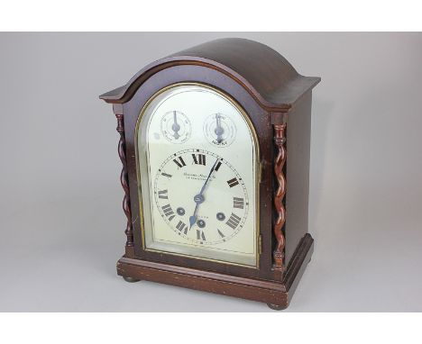 A Camever, Cuss & Co mahogany mantel clock with domed case, the silverised dial with Roman numerals and two secondary dials, 