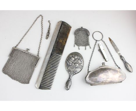 A Victorian silver mesh purse, a George V silver purse, a silver mounted comb, file, button hook and hand mirror (a/f), and a