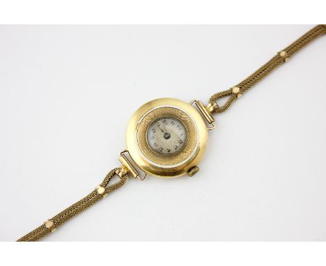 A ladies 18ct gold wrist watch the half hunter case with white enamel and engine turned decoration on a later gilt bracelet, 