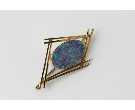 An opal doublet brooch the oval stone in an abstract style gold mount