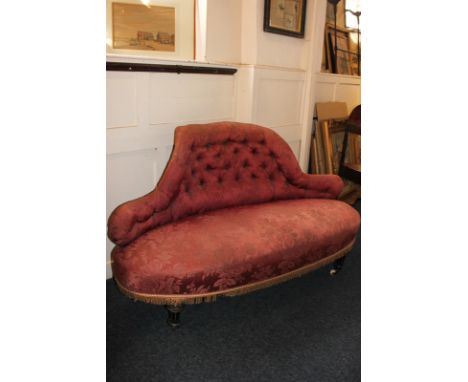 A Victorian sofa with shaped button upholstered back, oval seat on fluted turned feet and castors, 150cm