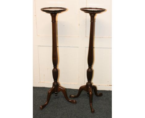 A pair of mahogany jardiniere stands on baluster stems and tripod bases, 93cm high