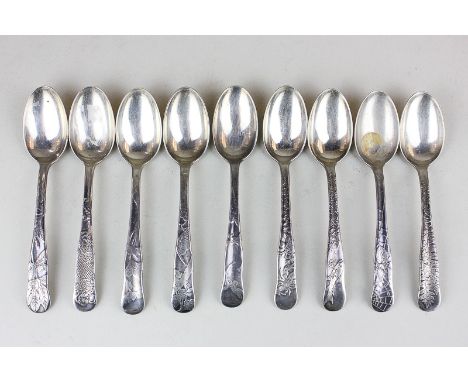 A set of nine Tiffany & Co sterling silver teaspoons with fish, fern and spider's web decorated handles, 5oz