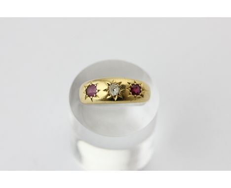 A ruby and diamond three stone ring in 18ct gold