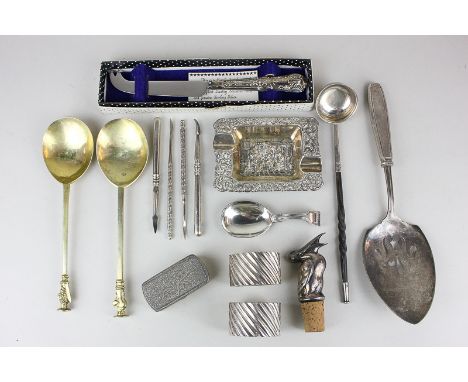 Two 18th century style gilt metal spoons with apostle seal handles, a pair of napkin rings, a whalebone handled toddy ladle, 