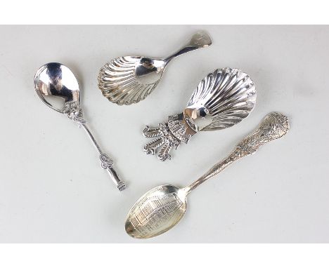 An Elizabeth II silver caddy spoon with shell shaped bowl, a sterling silver souvenir spoon of Chicago Public Library, an 800