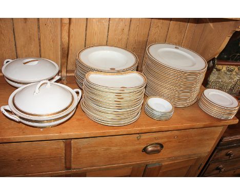 A Royal Worcester porcelain part dinner service with gilt border and single gilt roundel, comprising twenty-five dinner plate