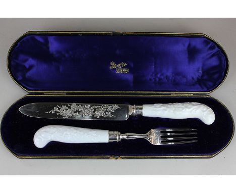 A cased set of Victorian silver serving knife and fork with floral ceramic handles and floral decoration, maker Richard Marti