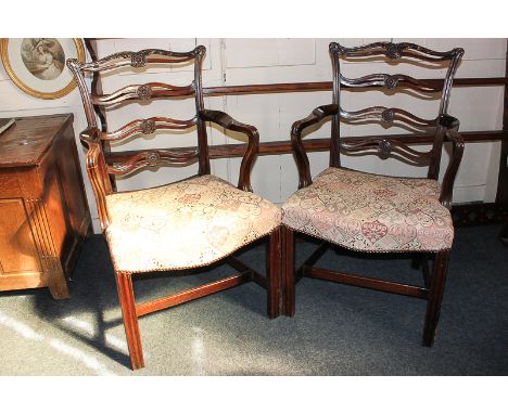 A pair of Chippendale style ladder back carver dining chairs with upholstered sets, on fluted legs