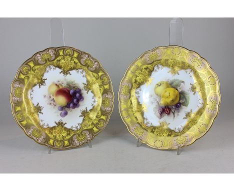 A pair of Royal Worcester porcelain cabinet plates, with hand painted central design of fruit, signed R Seabright with gilt e