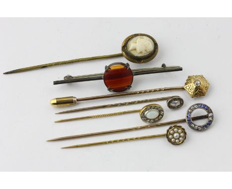 A rose cut diamond stick pin in case; a sapphire and diamond stick pin; and old cut diamond stick pin; an opal and diamond st