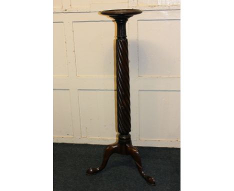 A mahogany torchiere with spiral turned support on tripod base and hoof feet, 116cm high
