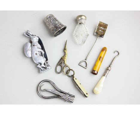 A collection of nine small objects of vertu including a miniature glass scent bottle, penknife and scissors, spade shaped cru